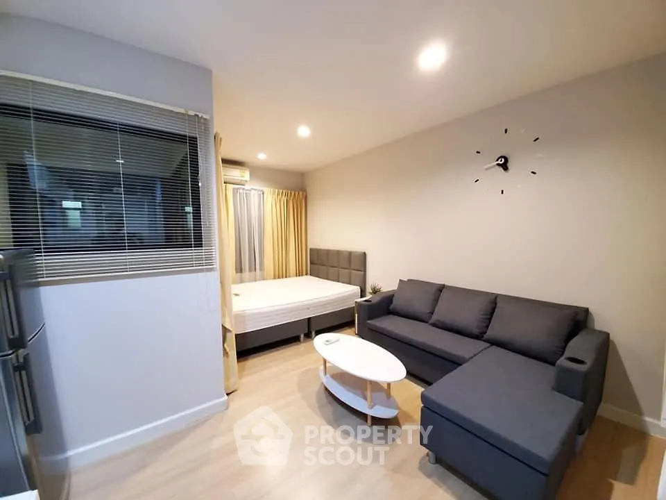 Modern studio apartment with cozy living area and stylish furnishings