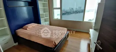 Stunning bedroom with river view and built-in shelving in modern apartment.