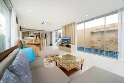 Spacious modern living room with pool view and open kitchen layout