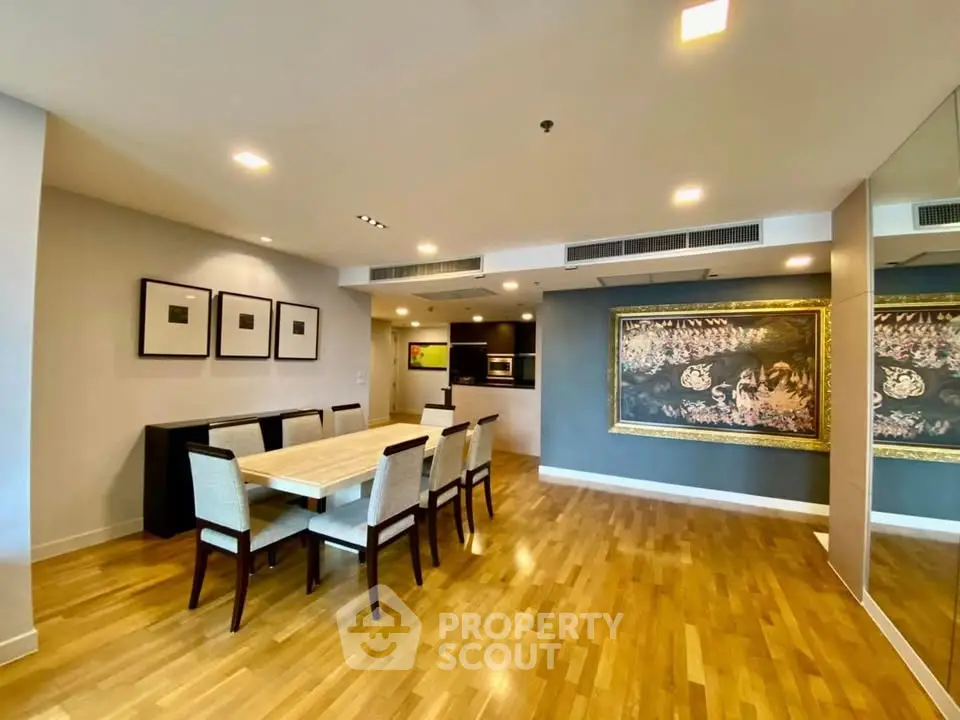 Spacious dining area with elegant decor and modern lighting in a luxury apartment.