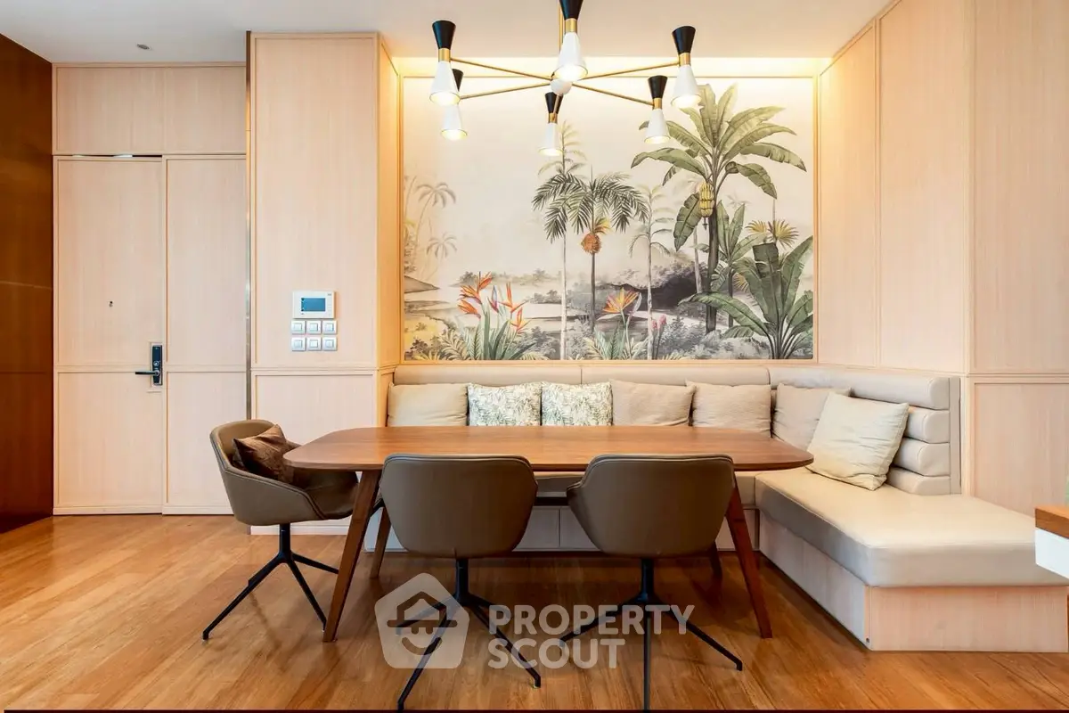 Stylish dining area with elegant wooden table and tropical wall art in modern apartment.