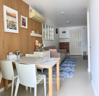 Charming living room with modern decor and cozy seating area, perfect for relaxation.