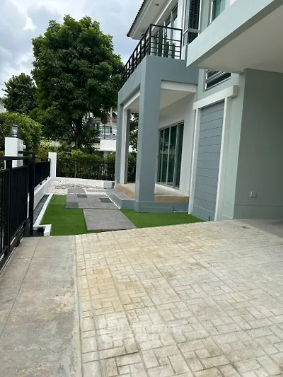 Modern house exterior with paved driveway and landscaped garden