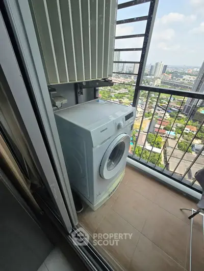 High-rise balcony with washing machine and city view, perfect for urban living.