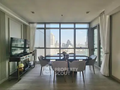 Modern living room with city view and elegant dining area