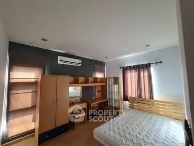 Spacious bedroom with modern furniture and natural light