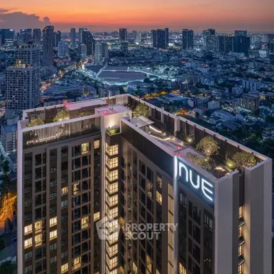 Stunning cityscape view from high-rise building rooftop at sunset.