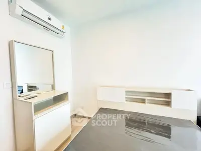 Modern bedroom with sleek furniture and air conditioning, perfect for comfort and style.