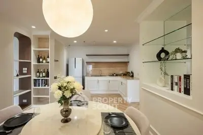 Elegant dining area with modern kitchen and stylish decor, perfect for entertaining guests.