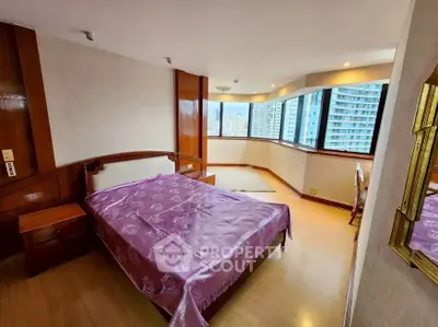 Spacious bedroom with city view and elegant wooden accents