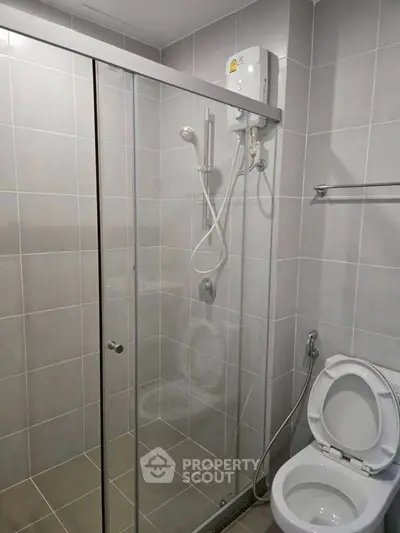 Modern bathroom with glass shower enclosure and sleek fixtures