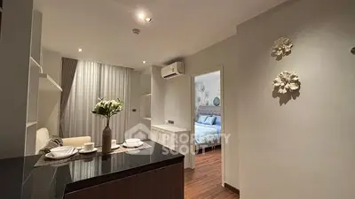Modern open-layout kitchen and cozy bedroom in stylish apartment