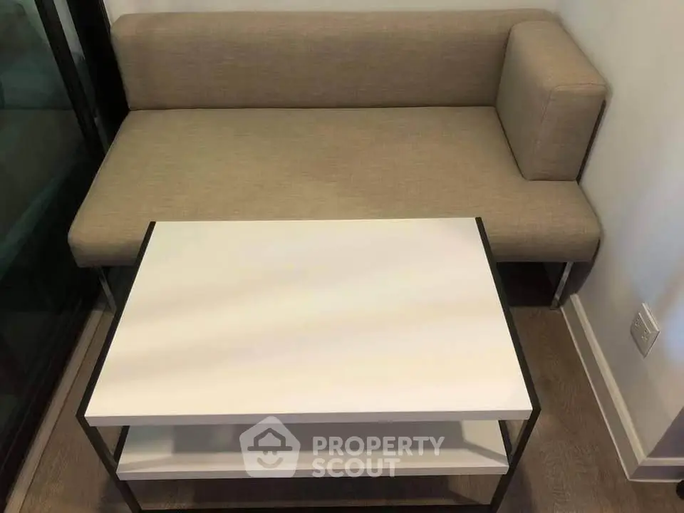 Modern minimalist living room with sleek sofa and stylish coffee table, perfect for urban living.