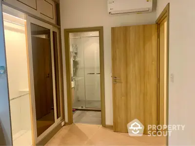 Modern interior with wooden doors and glass shower enclosure