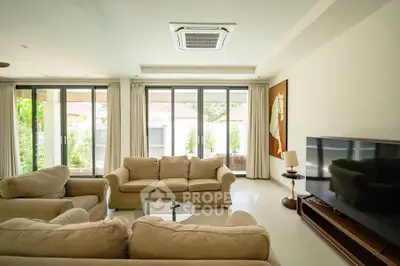 Spacious living room with modern furniture and large windows for natural light