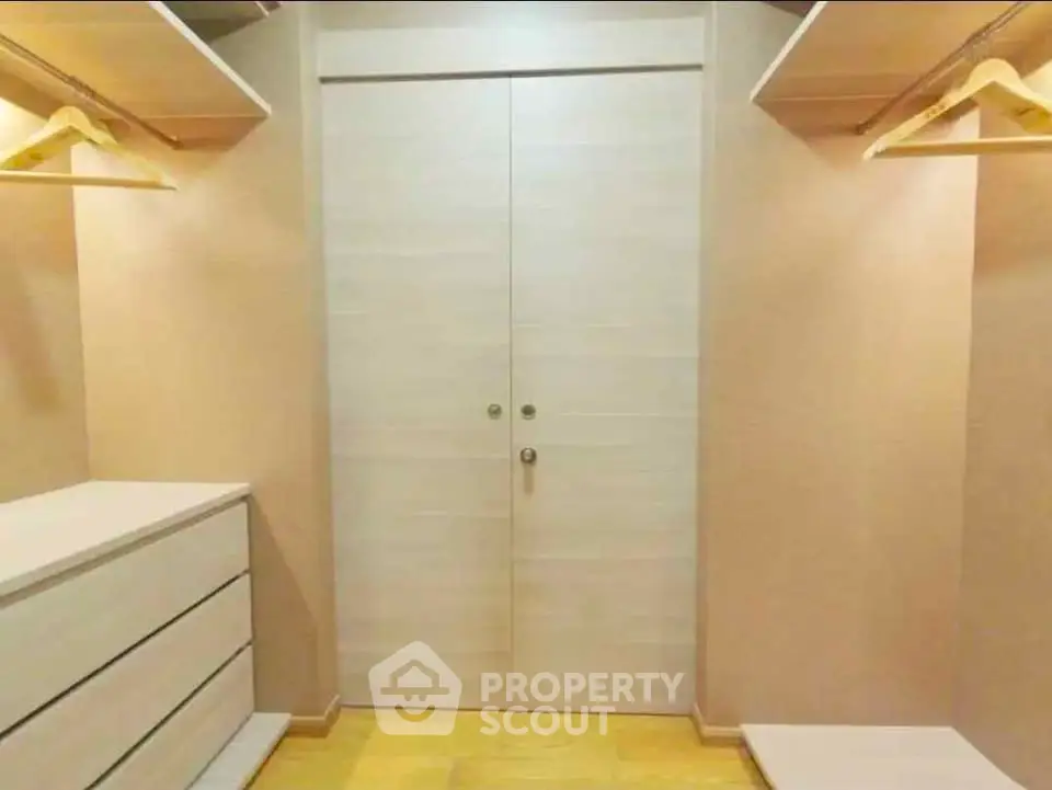 Spacious walk-in closet with ample shelving and storage space
