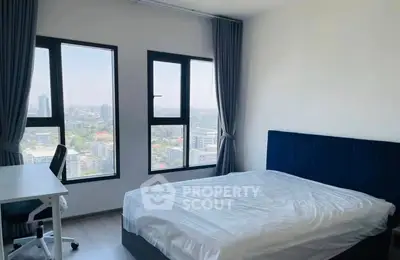 Modern bedroom with stunning city view and sleek furnishings