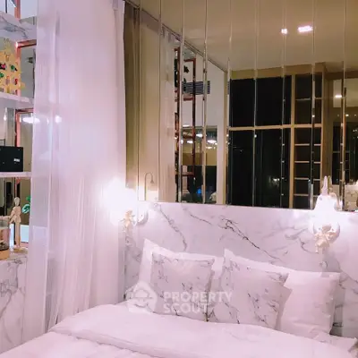 Luxurious bedroom with marble accents and elegant lighting, perfect for a serene retreat.