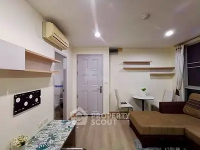 Cozy living room with modern decor and air conditioning, featuring a comfortable sofa and stylish shelving.