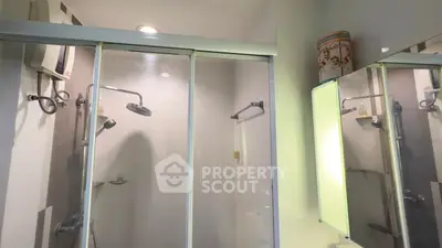 Modern bathroom with glass shower enclosure and elegant fixtures