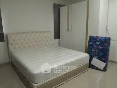 Spacious bedroom with elegant bed and modern wardrobe, perfect for comfort and style.