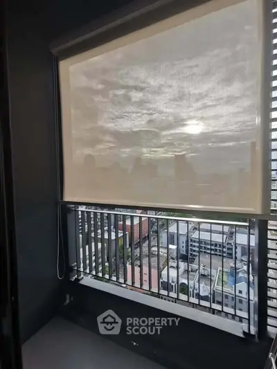 Modern balcony with city view and sunshade in urban apartment