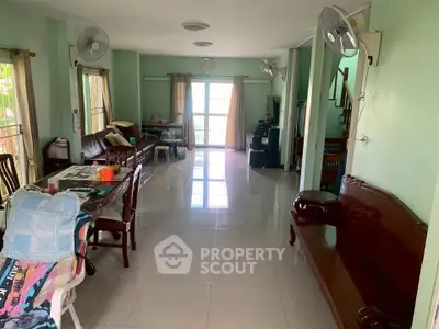 Spacious living room with natural light and elegant furnishings, perfect for family gatherings.