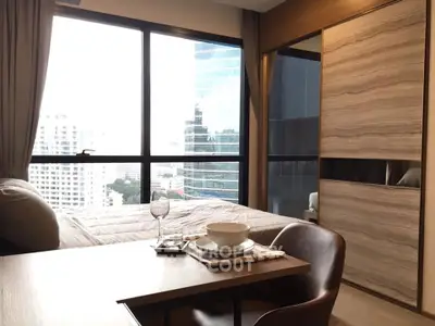 Modern bedroom with city view and stylish dining setup