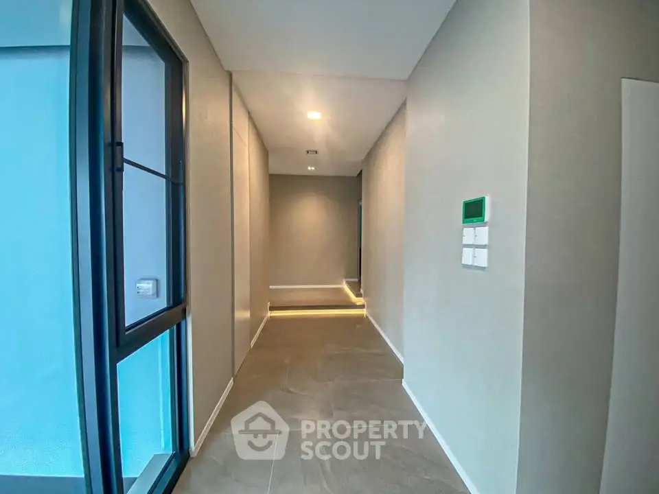 Modern hallway with sleek design and ambient lighting in a contemporary building.