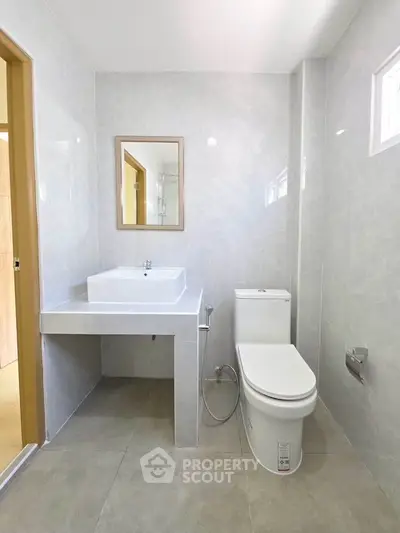 Modern bathroom with sleek fixtures and elegant tile design, featuring a spacious layout and natural lighting.