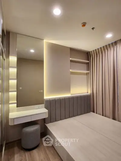 Modern bedroom with sleek design, built-in lighting, and elegant furnishings for a cozy ambiance.