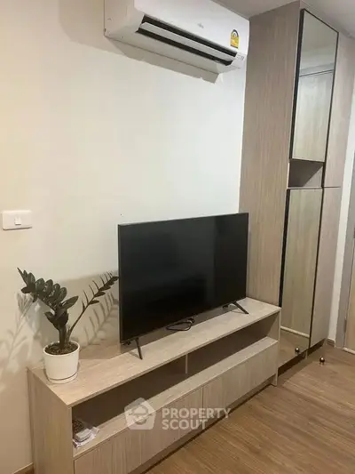Modern living room with sleek TV stand and air conditioning unit