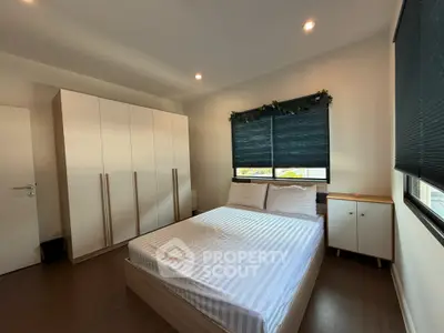 Spacious bedroom with modern furnishings and natural light