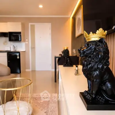 Luxurious living room with elegant decor and modern kitchen appliances, featuring a regal lion statue.