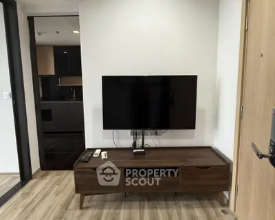 Modern living room with sleek TV setup and stylish wooden flooring