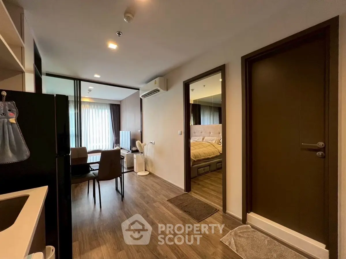 Modern apartment interior with open layout, featuring a cozy living area and stylish bedroom.