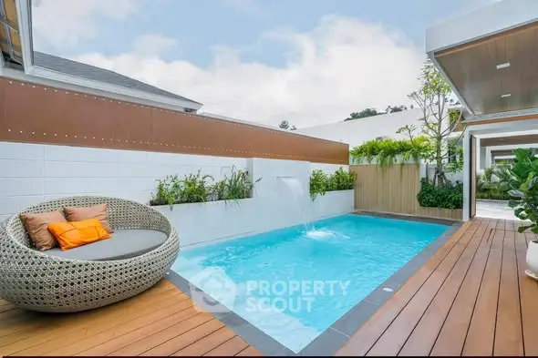 Luxurious modern outdoor pool area with stylish seating and lush greenery, perfect for relaxation and entertainment.