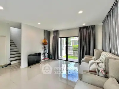 Spacious living room with modern decor and garden view