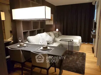 Modern studio apartment with cozy living area and stylish dining setup.