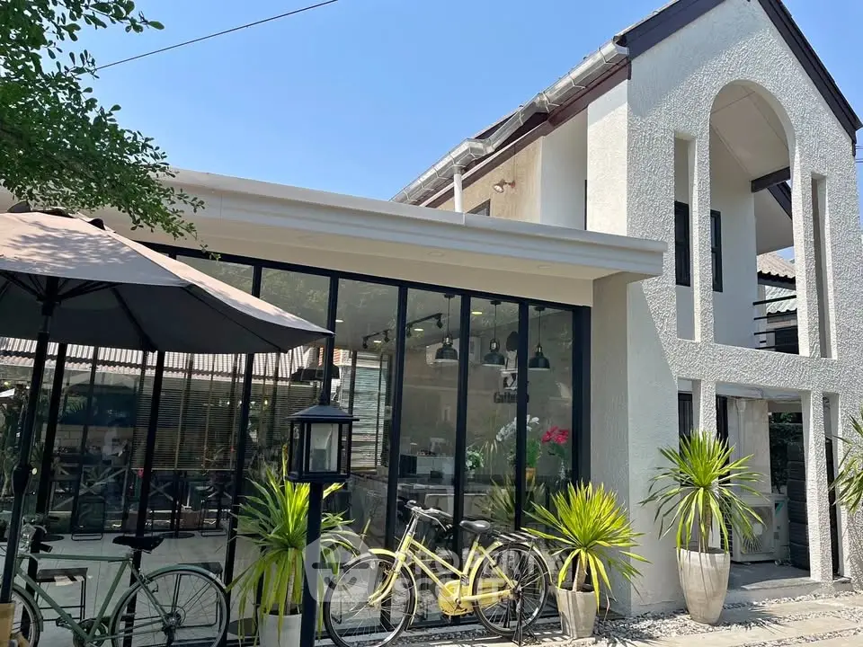 Charming modern house with large windows and stylish outdoor area, perfect for contemporary living.