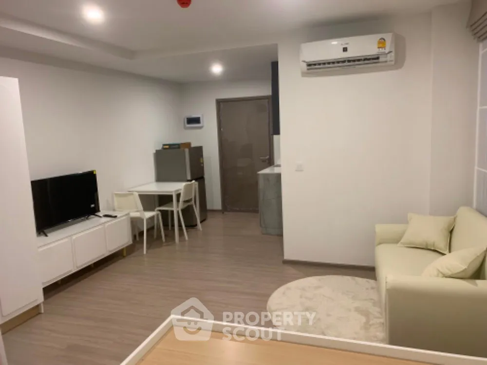 Modern living room with sleek furniture and air conditioning in a cozy apartment.