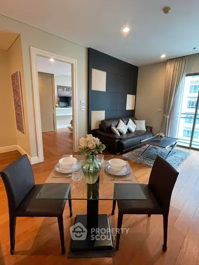 Modern living room with elegant dining area and stylish decor in a luxurious apartment.