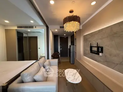 Modern living room with elegant chandelier and marble coffee table