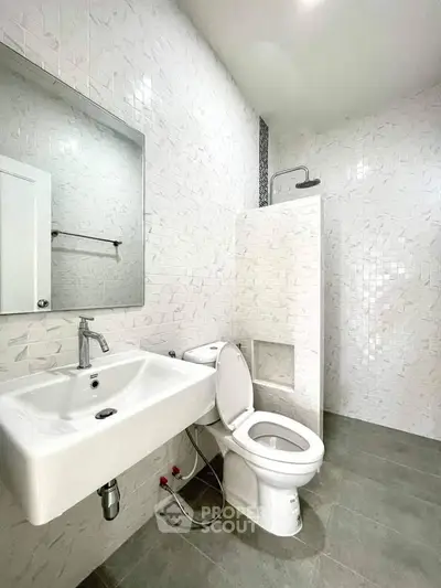 Modern bathroom with sleek white tiles and contemporary fixtures