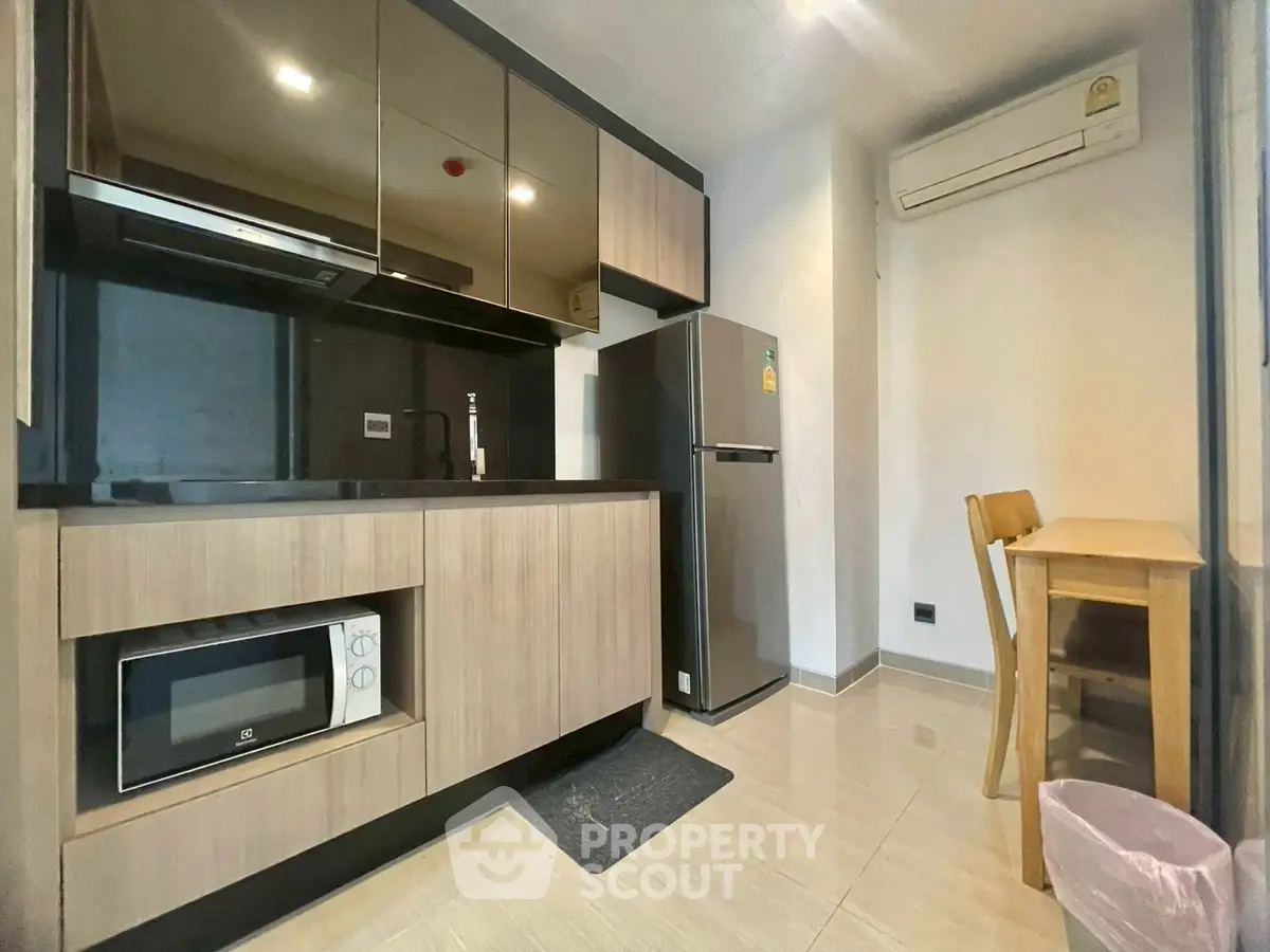 Modern kitchen with sleek cabinetry and appliances in a compact layout
