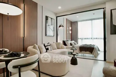 Modern open-plan living room with stylish decor and cozy bedroom view, perfect for urban living.