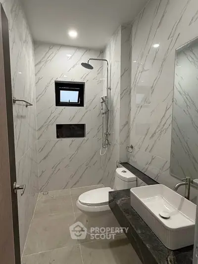 Modern bathroom with marble tiles and sleek fixtures