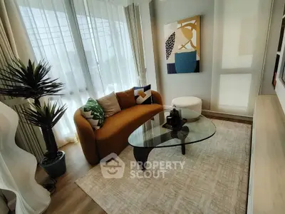 Stylish modern living room with elegant furniture and large windows