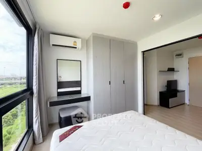 Modern bedroom with large window and view, featuring built-in wardrobe and air conditioning.