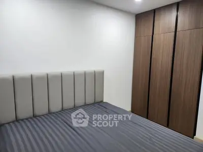 Modern bedroom with sleek wardrobe and stylish bed